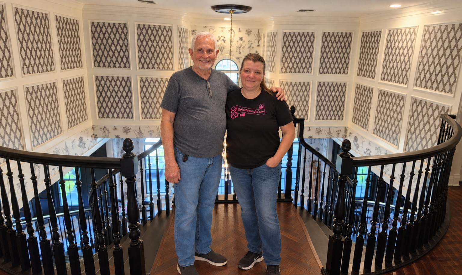 Vena Townsend standing with wallpaper installer and mentor Steve Wood